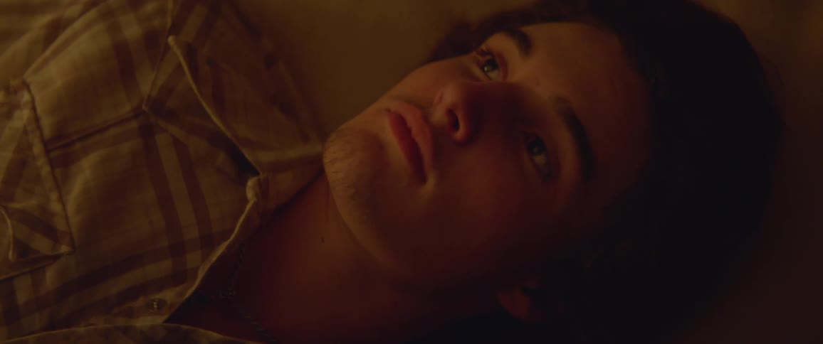 A resting man is opening his eyes