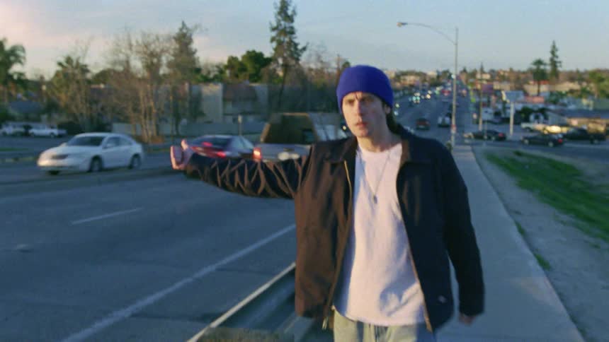 A man his hitchhiking near the highway