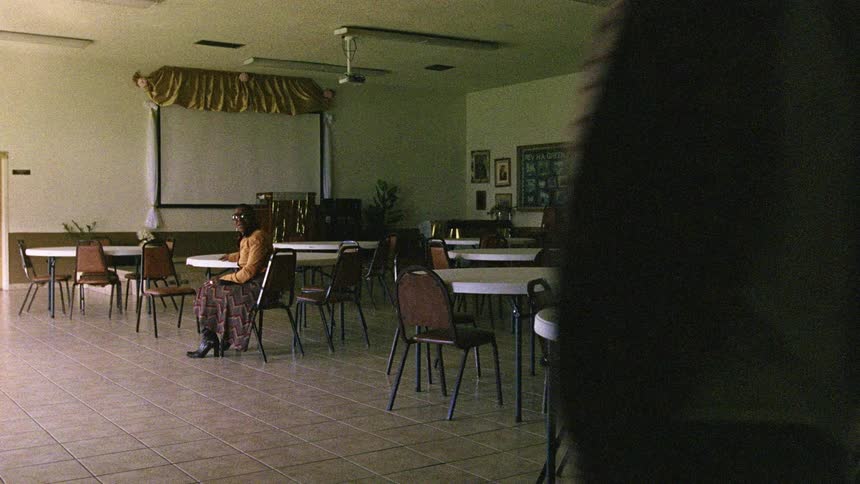 Man stomps away after sitting and talking with woman at table in food establishment