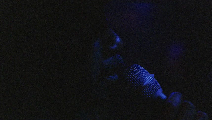 A man sings in a night club