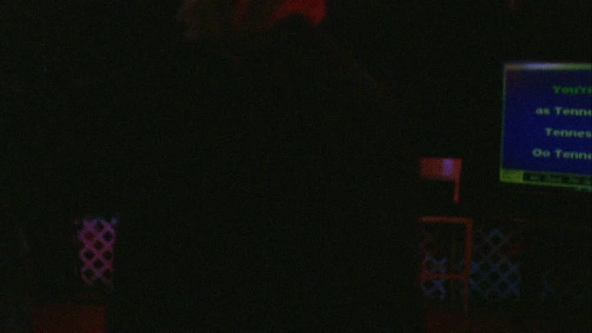 Two people dance on the dark dance floor