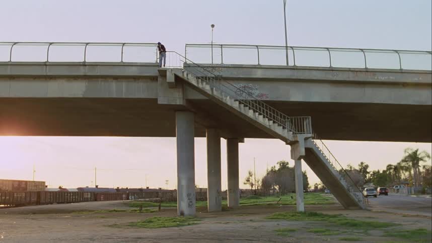 The sun is rising past the overpass