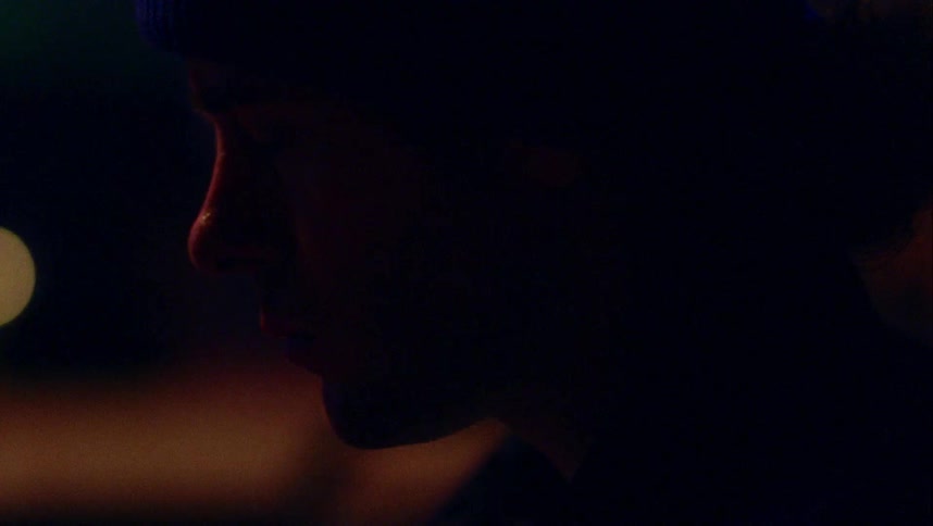 Mans profile is partly silhouetted in darkness as he swallows