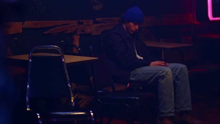 A man sits in the dark room