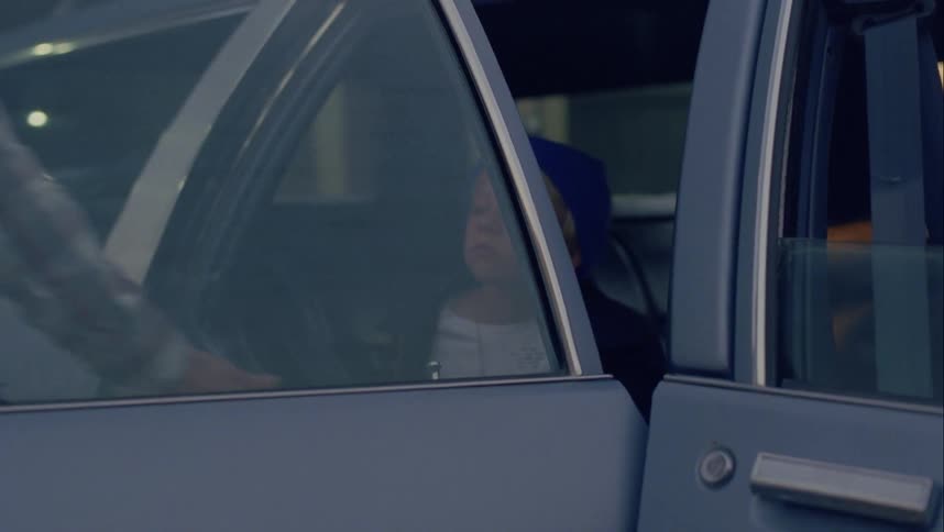 Father opens door for son and escorts boy away from car toward building