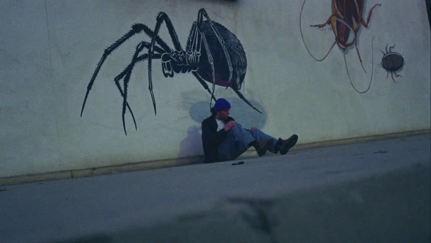 A man gets up from the concrete floor