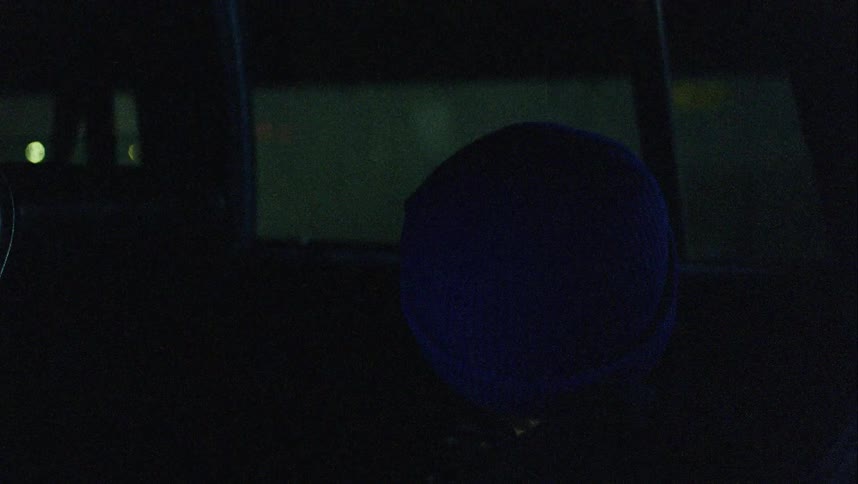 A boy looks around nervously in the car as a man approaches