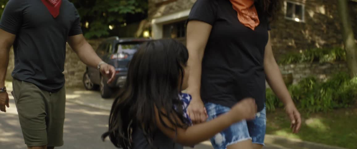 A family walk down the neighborhood street
