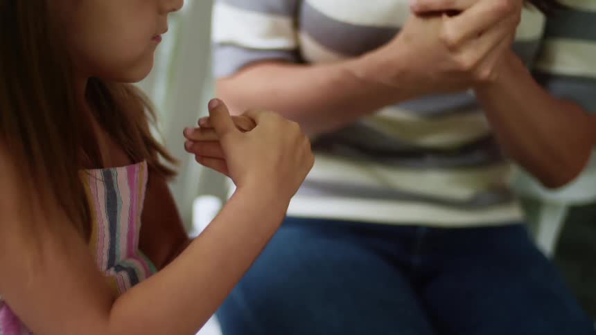Girl mimics woman rubbing hands properly