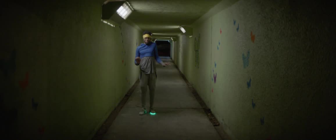 A man dances in a hallway