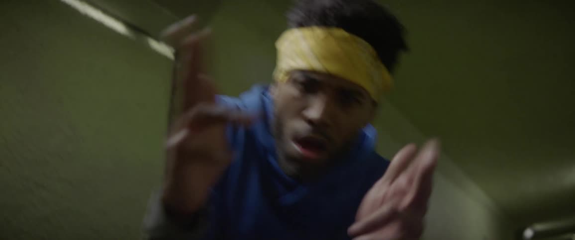 A man is dancing in a tunnel at night