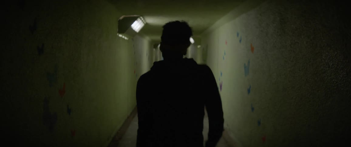 A man dances in a hallway