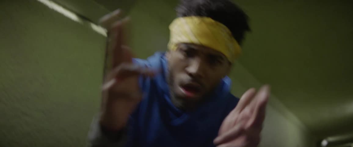 A man is dancing in a tunnel at night