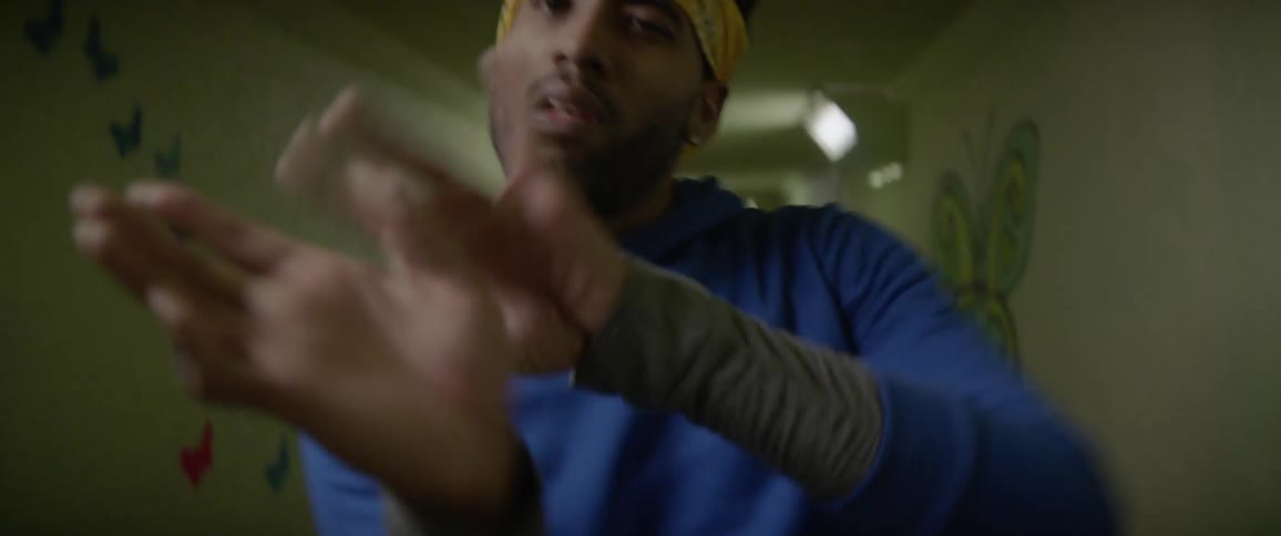 A man is dancing inside of a long hallway