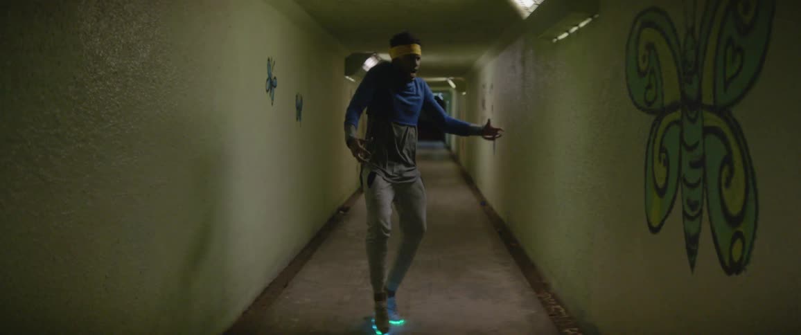 A man sways around dancing in the dark tunnel