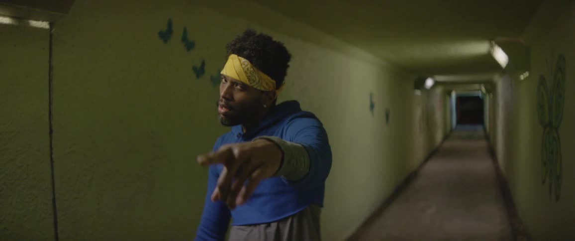 A man dances in a hallway