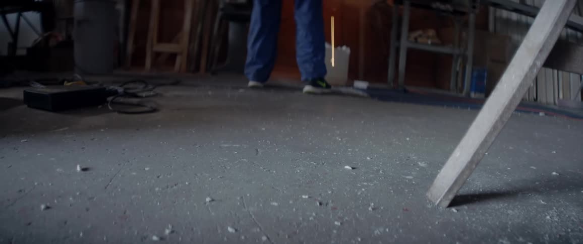 A man uses a grinding saw in a workshop