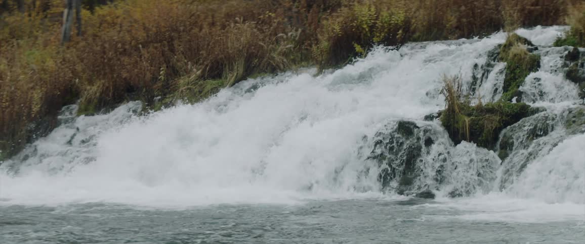 The water pours fast over the stream rocks