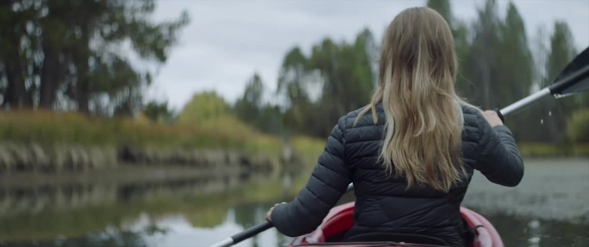 A woman kayaks on the water