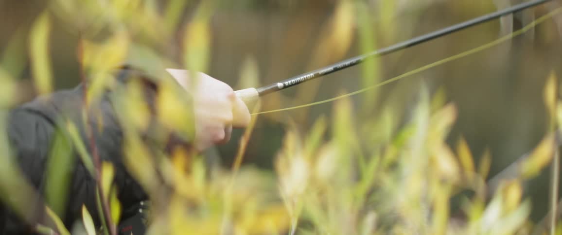 A man is fishing during the day