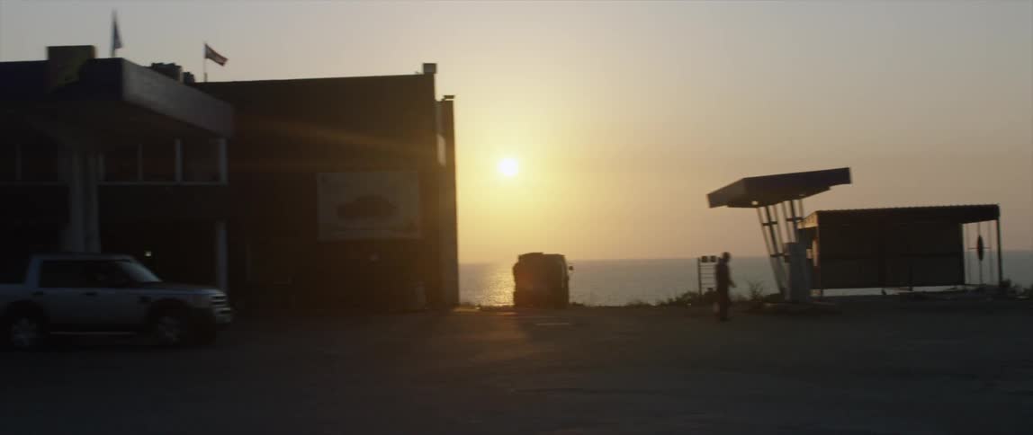 The sun setting behind a row of businesses