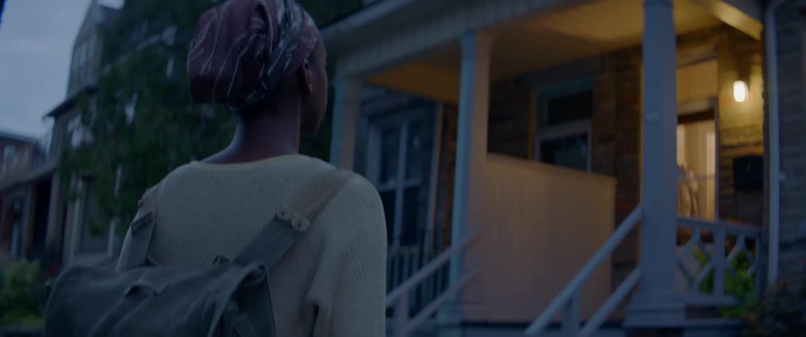 Woman approaches a house at night