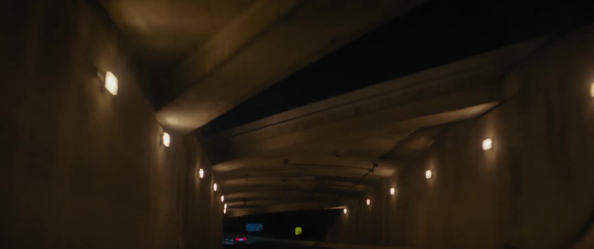 A car is driving into a tunnel