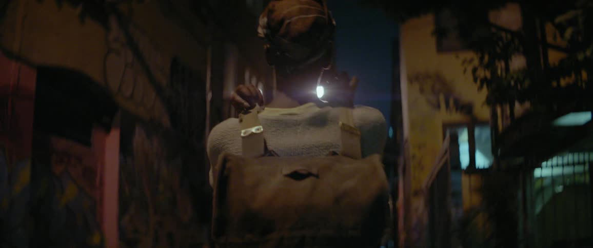 Woman walks alone in a city at night