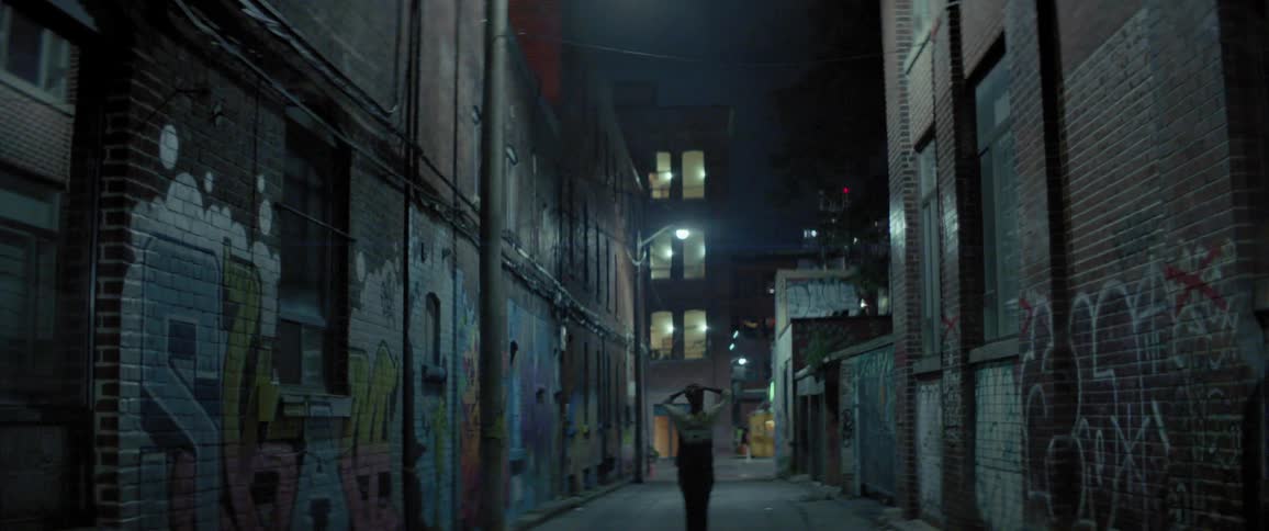 A person walks down an alleyway