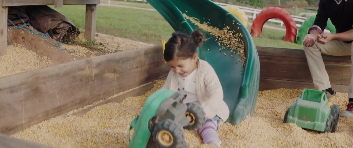 A girl goes down a slide on a playground
