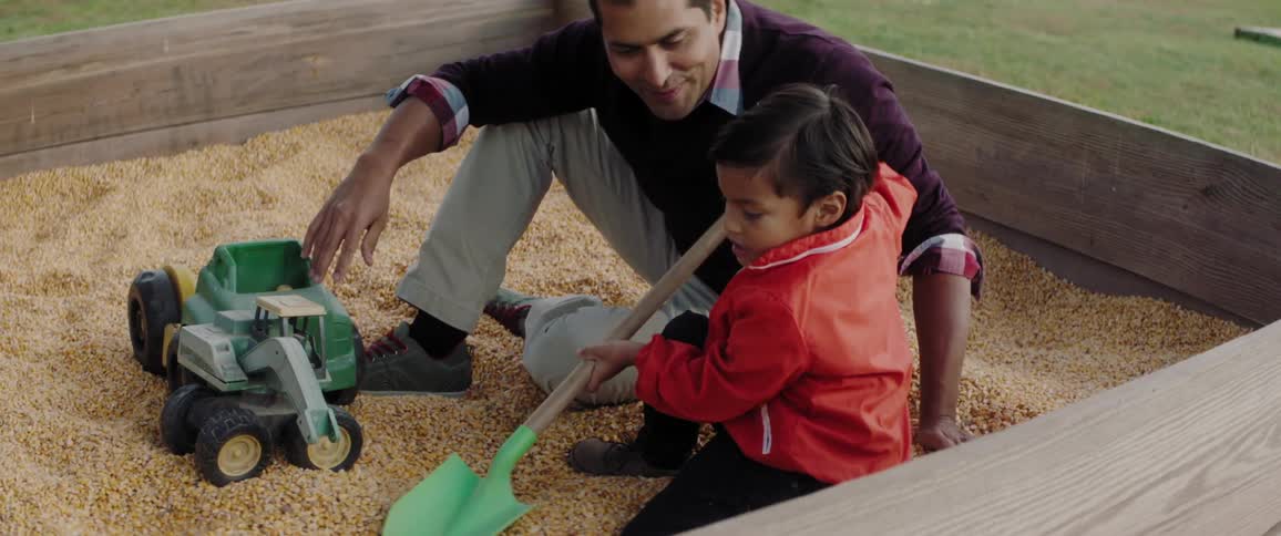 A family plays in a sandbox