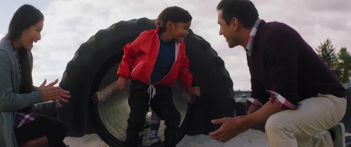 A kid is making his way through a tunnel on a playground