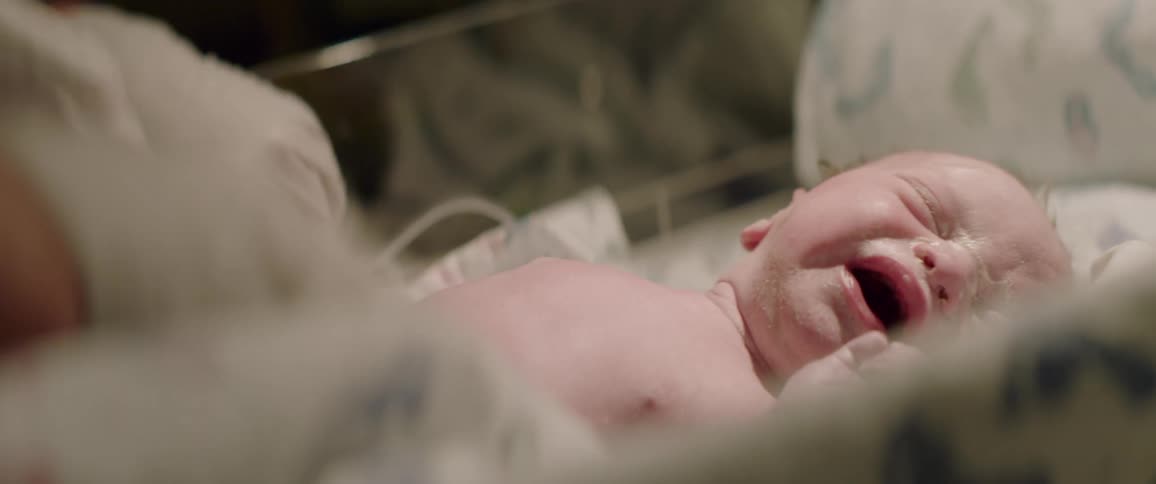 A baby cries in an incubator