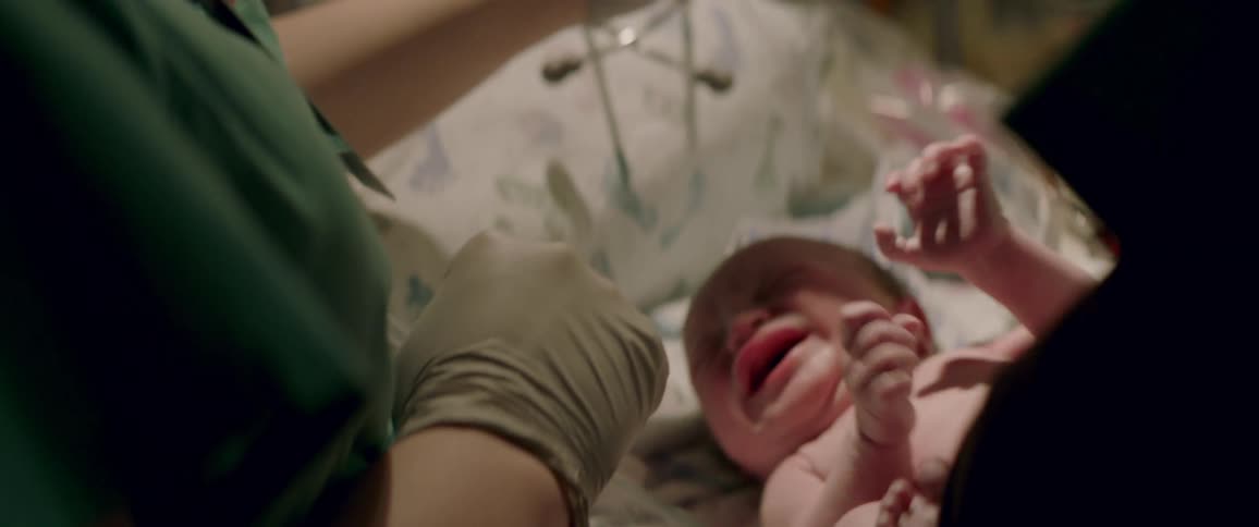 Person moves tubes away from a crying infant