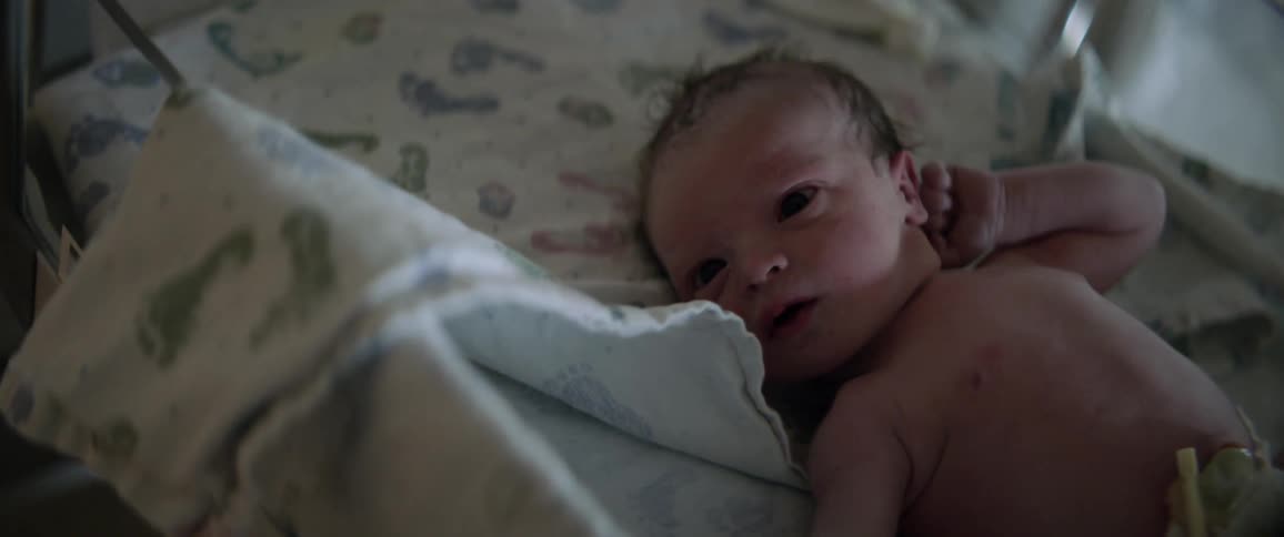 A baby wakes up in the crib