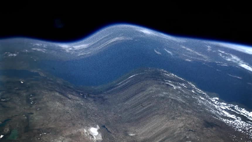 The planet earth can be seen from outer space but it appears severely warped by a large wave of distortion
