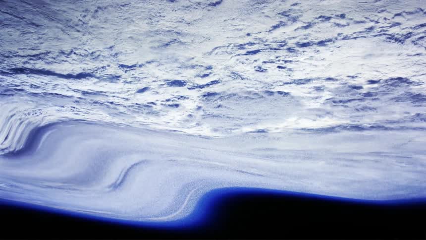 The cloud covered atmosphere of the planet earth can be seen from outer space but the image of it appears warped and distorted