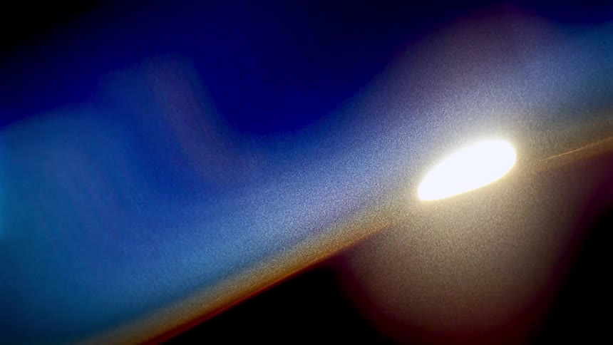 Blue orange white and black colors that look like a sunset on the horizon