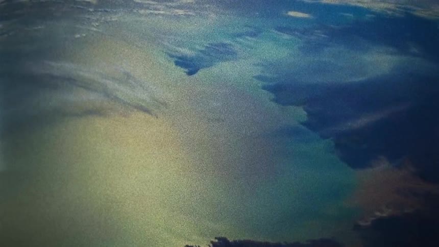 The daytime sky being reflected on a constantly distorting surface