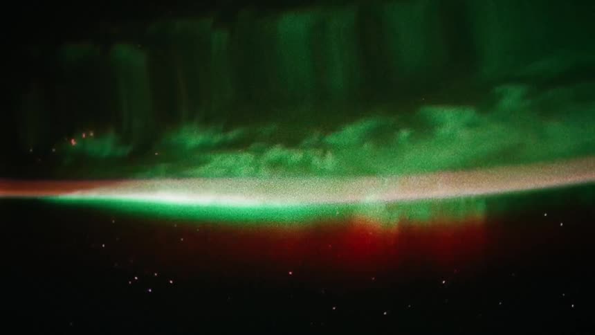 A green hued planet can be seen from outer space and it appears severely warped by a large wave of distortion rolling across it