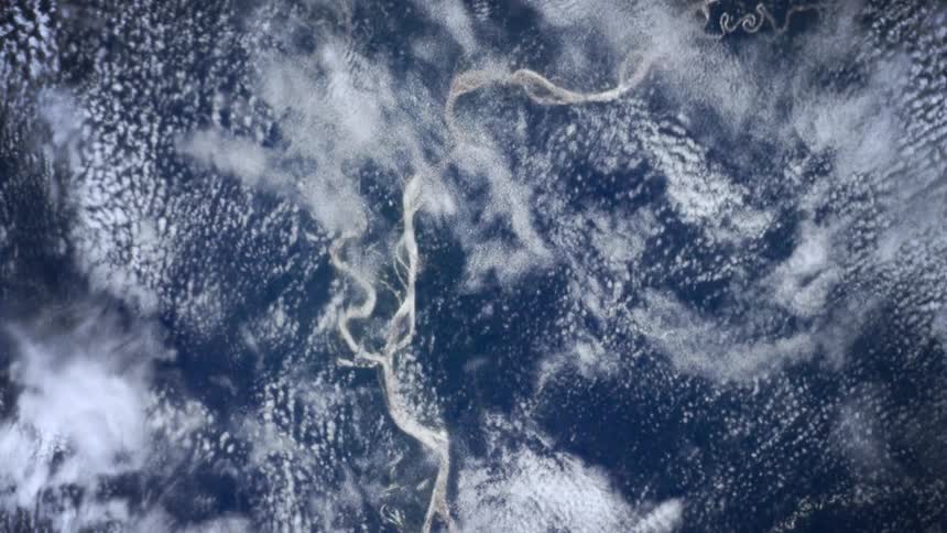 The clouds move across the top of the ocean