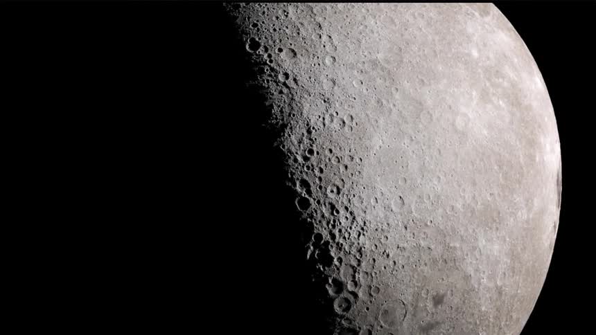The surface of the moon is illuminated and reveals countless impact craters covering it