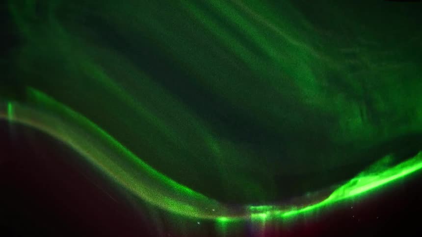 The northern lights shine in the sky at night