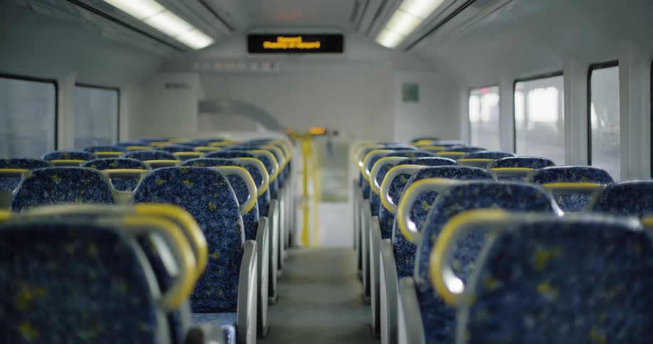A bus travels on a city street with empty seats