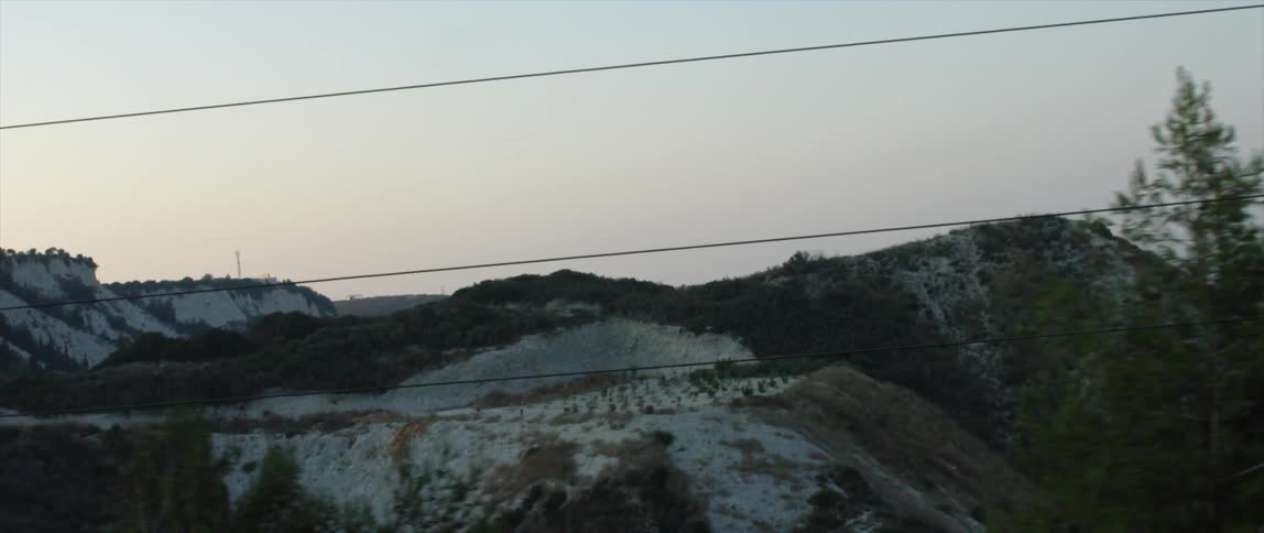 Power lines and snowy hills on a clear day