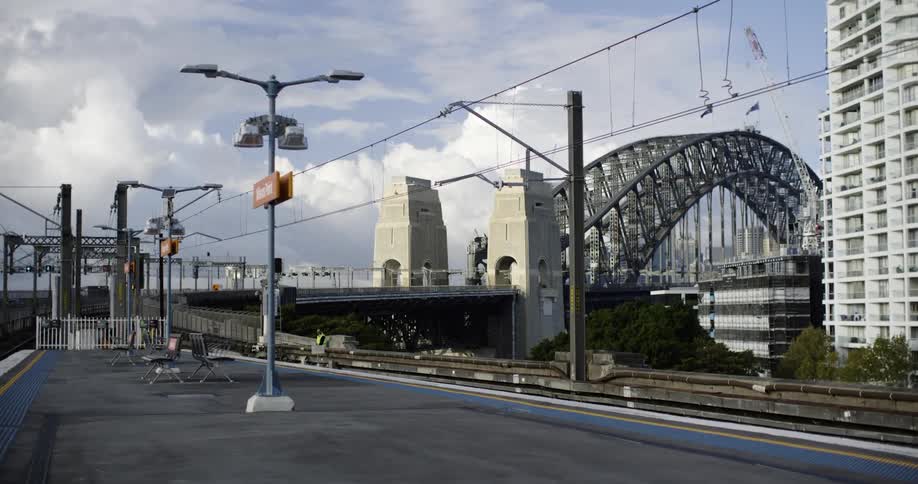 A walkway near a freeway bridge in a city during the day