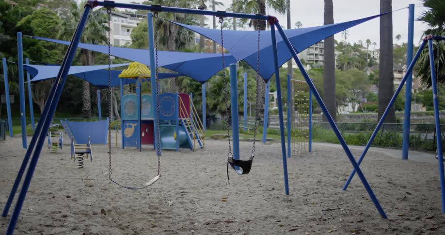 The swings hang in the empty playground