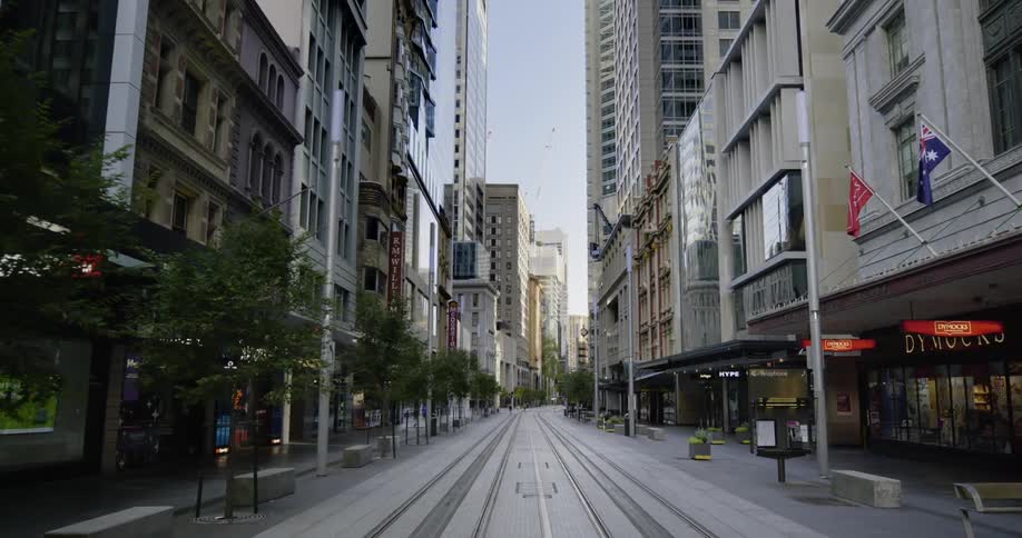 Empty big city street with tall buildings and shops during lockdown due to coronavirus