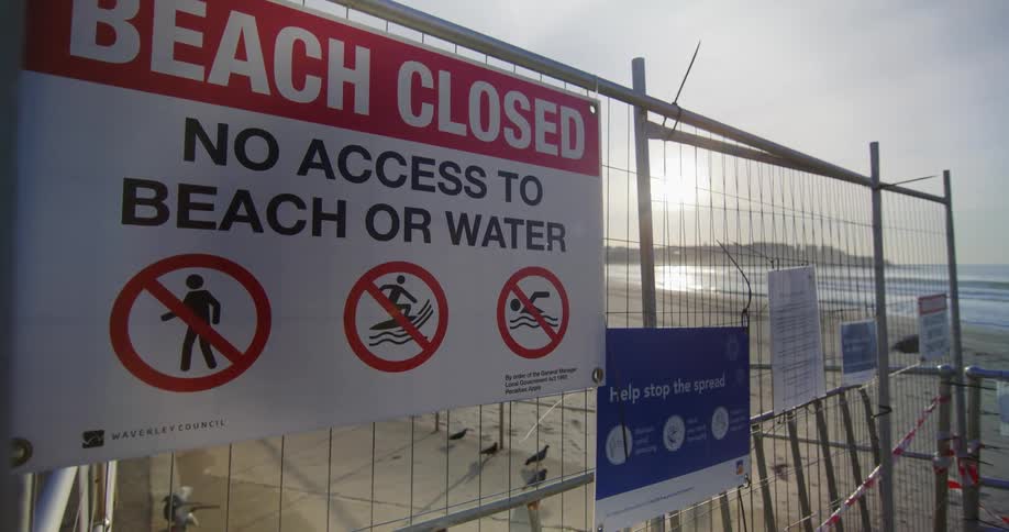 Signs on a gate barring access to a closed beach