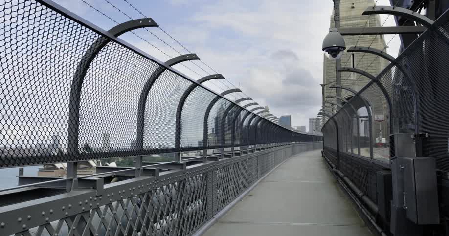 Empty fenced pedestrian walkway show city and sydney opera house nearby